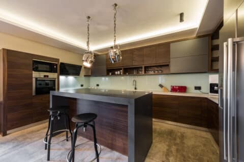 completed kitchen remodel using wood cabinets and warm tones